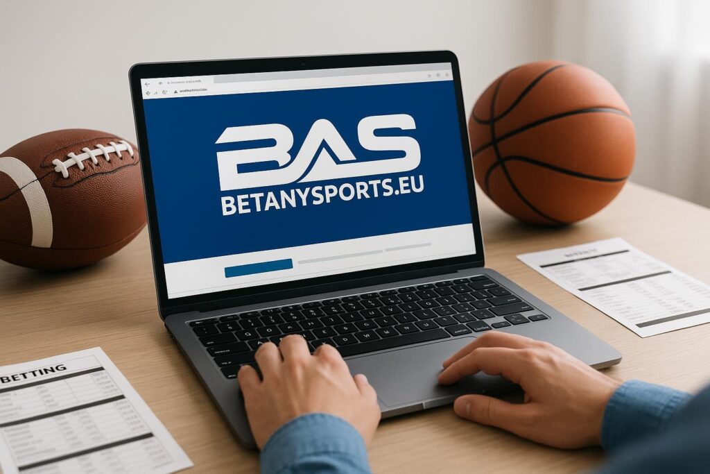 Laptop displaying BetAnySports site next to sports equipment for an in-depth BetAnySports Review showcasing user experience and betting features for sports enthusiasts.